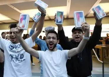 Mazen Kourouche, uno de los primeros compradores del iPhone X, muestra su adquisición junto a otros compradores durante el lanzamiento general al público del nuevo celular en una tienda Apple de la ciudad de Sydney (Australia) (EFE)